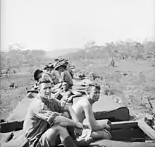 Soldiers ride on the roof of a troop train