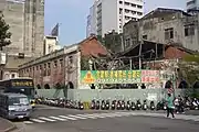 The building in 2010, prior to its renovation. The green banner is an advertisement to sell the land.