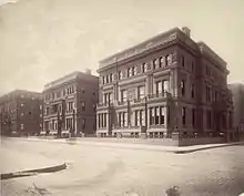 Three ornate three-story square mansions