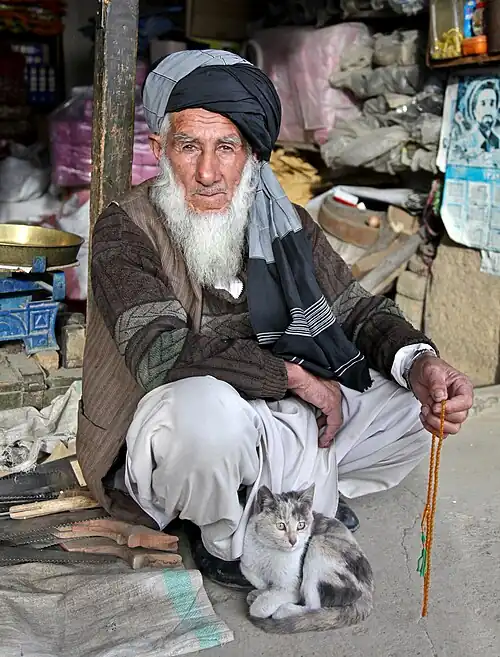 An Afghan elder sits outside his store at the Anaba bazaar in Panjshir, Afghanistan