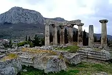 Image 29Ruins of the Temple of Apollo within the polis of Ancient Corinth, built c. 540 BC, with the Acrocorinth (the city's acropolis) seen in the background (from Archaic Greece)