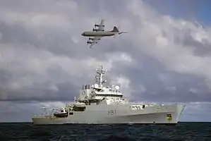 4-engined plane flies over ship