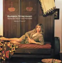 The singer's appears spread out on a long chair with her left hand arched in order to support herself.