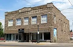Photograph of a 2-story, stone-faced commercial building