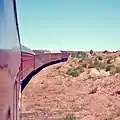 Flash floods regularly washed away bridges and track on the narrow-gauge railway. The Ghan is climbing out of the Finke River depression after track was laid on the river bed as a cheap solution.