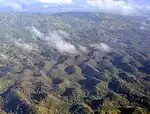 Aerial view of the Chocolate Hills, Bohol, Philippines, exhibiting both mogotes and cockpit karst characteristics.