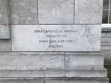 A stone on the side of the building, on which is engraved the words: "Jones and Kelly, M.M.R.I.A.I. Architects John Sisk and Son Builders"