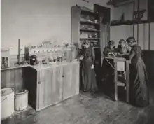 Photograph of Cornelia Clapp with students working in a zoology laboratory