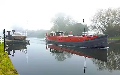 Motorised Dutch Barge passing a swing bridge on the Gloucester & Sharpness Canal