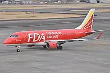 Fuji Dream Airlines Embraer 170 in red livery at Nagoya Airfield
