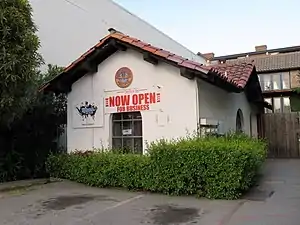 A white stucco building with a tile roof
