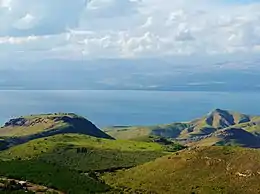 Green-covered hills overlooking a large lake