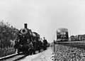 A group of railwaymen at the decorated steam locomotive NS 4310 (ex War Department no. 70863), presumably in Gorinchem or Giessendam, during the farewell of this steam locomotive (depot Rotterdam RMO). A diesel-electric train set DE 3 (series 11-50) passes on the right. (28-09-1957)