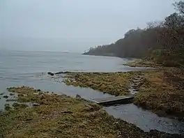 The sea seen from the bay, with a small path running on the coastal edge