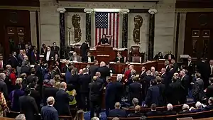 Nancy Pelosi presides over a crowded House of Representatives chamber floor during the impeachment vote