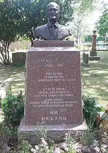Bronze bust of Layton atop of a red granite pillar