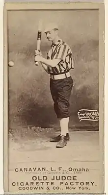 Standing man in baseball uniform with bat