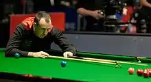 Mark Williams holding a cue