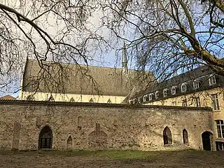 The cloister's south wall still features 13th-century blind windows and arches.