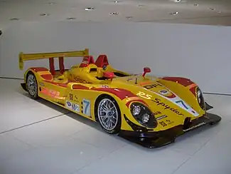 Picture of bright yellow and red RS Spyder racing car in a museum