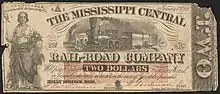 Two dollar note. Illustrated with a woman on the left and a train in the middle. Inscribed text reads "RECEIVABLE in payment of all dues to the Co. January 1st, 1862. THE MISSISSIPPI CENTRAL RAIL-ROAD COMPANY Will pay to bearer TWO DOLLARS in current, Bank or Confederate State notes, when the sum of Five dol is presented. HOLLY SPRINGS, MISS."