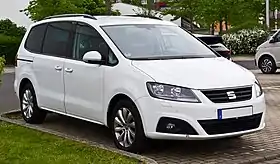 Front three-quarter view of a five-door road car with sliding rear-passenger doors.