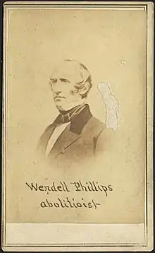 Photograph of Wendell Phillips with the caption "Wendell Phillips, abolitionist"; there is an abrasion on the right side of the image, above the subject's shoulder