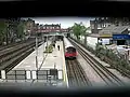 West Hampstead tube station seen through the anti vandal grill on the footbridge between Blackburn Road and Broadhurst Gardens, 27 April 2007.