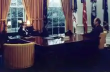  Nixon seated behind the Wilson desk and Ford seated next to it.